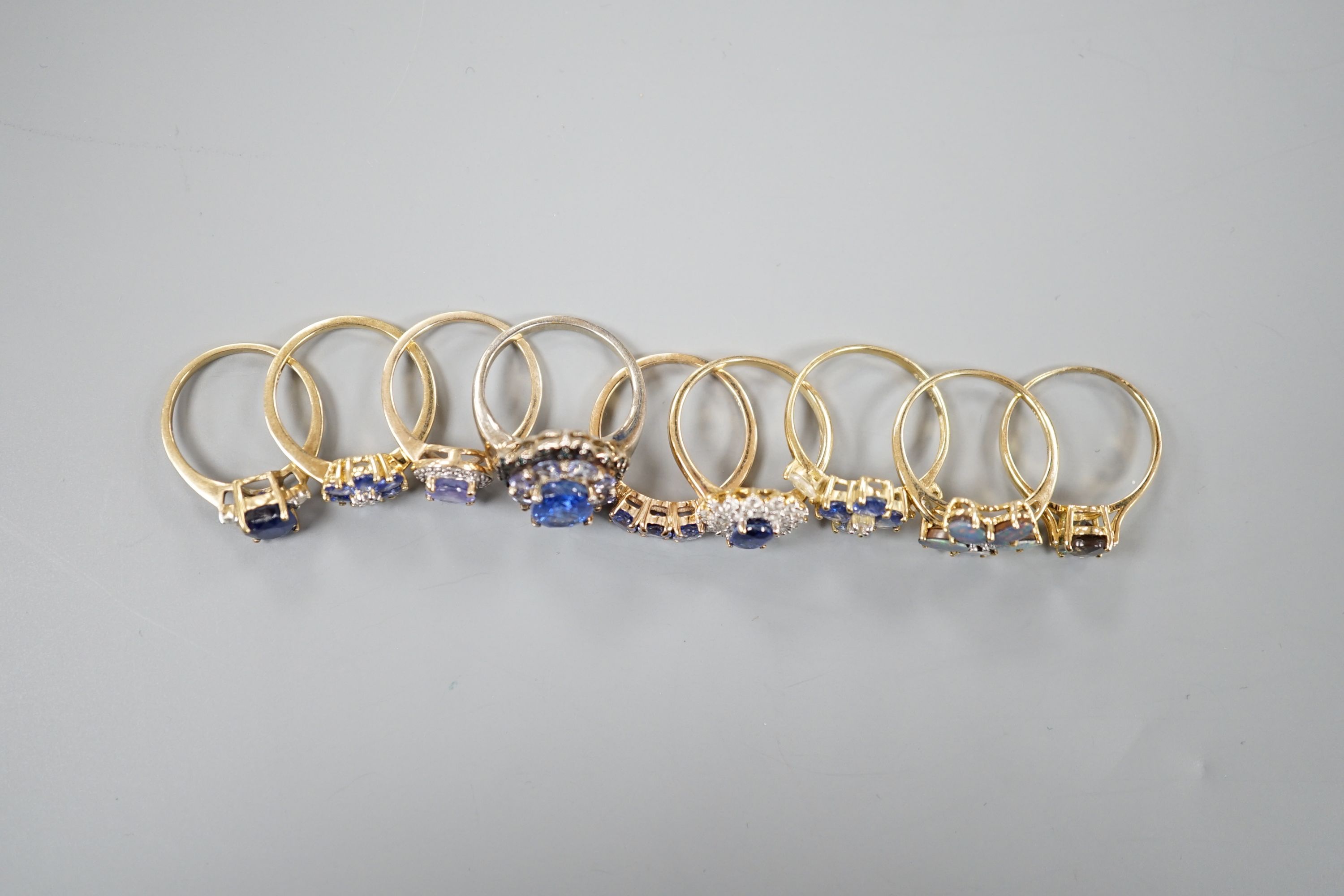 Eight assorted modern 9ct gold gem set rings, including opal doublet, gross 17.7 grams and a 925 ring.